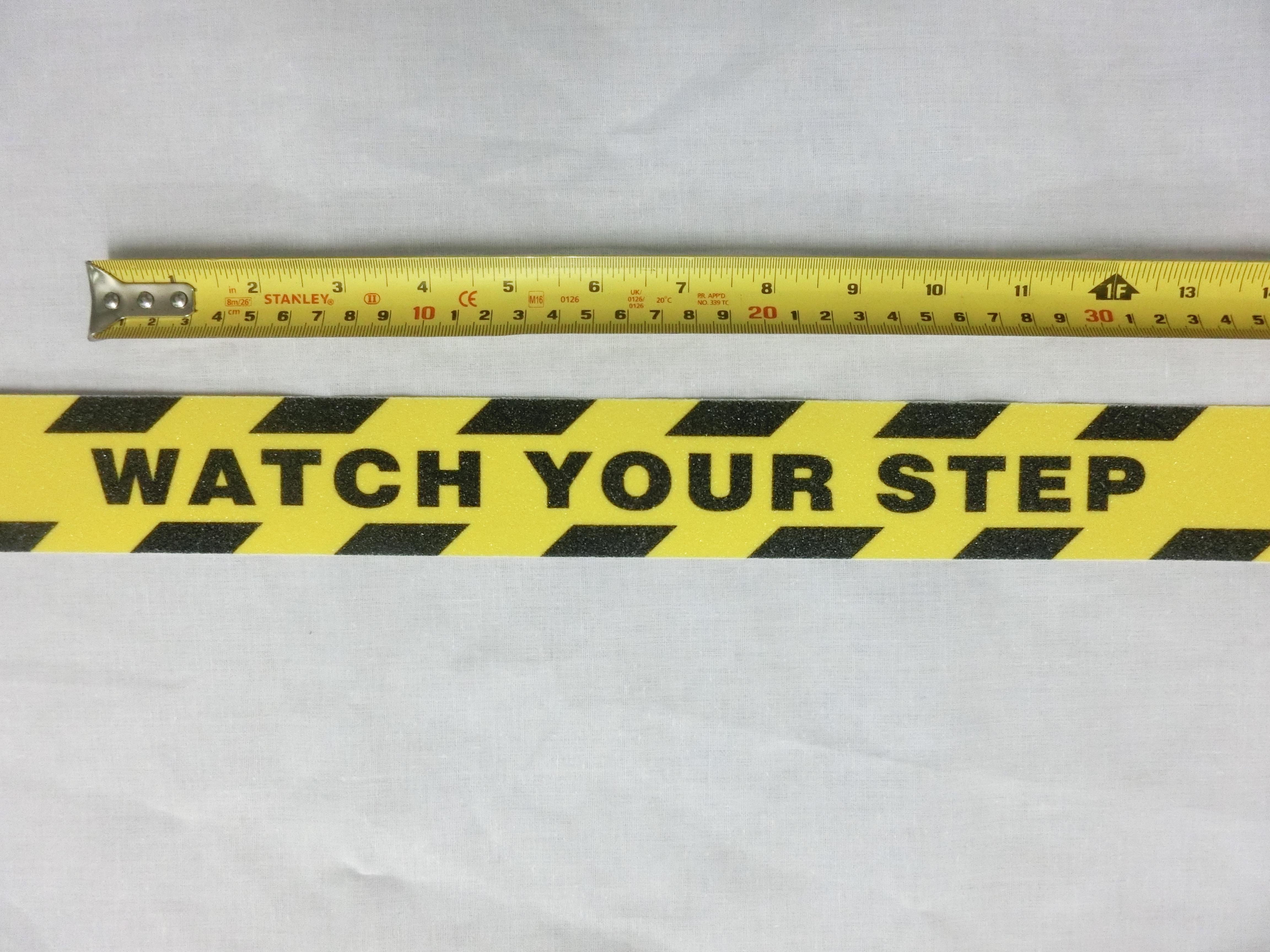 ANTI SLIP TAPE เทปกันลื่น สีเหลืองดำ หน้ากว้าง 2" ยาว 5 เมตร มีข้อความ " WATCH YOU STEP " เทปมีกาว ผิวหยาบ สำหรับติดบันได ทางเดิน